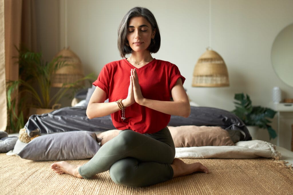 Why I Feel Nausea During Yoga — And How I Finally Stopped It A woman in a red shirt is doing yoga